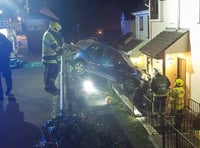 Driver has lucky escape after freak crash leaves car hanging