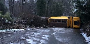 Gritter overturns as roads turn treacherous