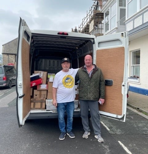 Darren Hopley, Dartmouth Yacht Club Manager, helping Mark Paine, from the Ukraine Sunflower Aid charity, load boxes onto his van ready to be taken into Ukraine