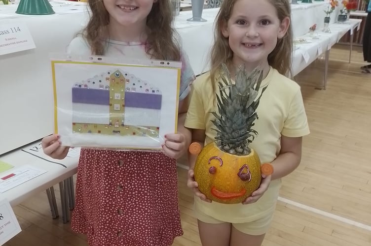 Betsy and Maisy Young proudly holding their work