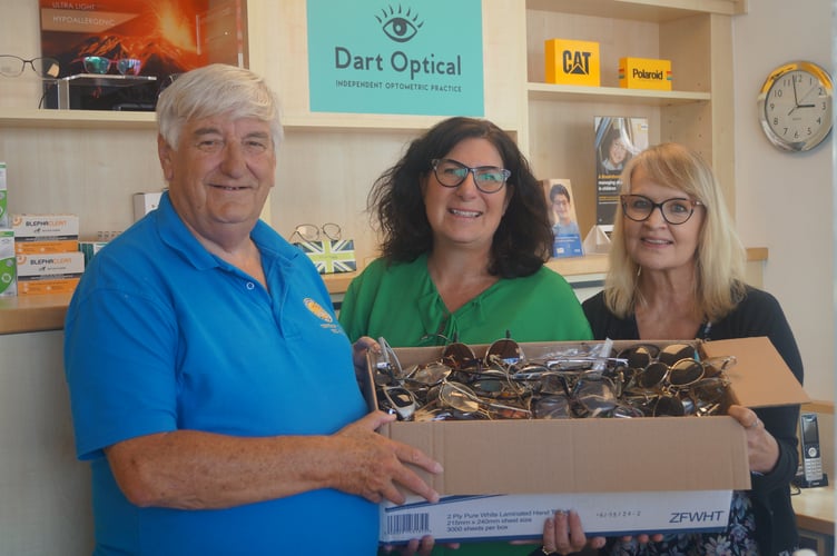 Dart Optical owner Lisa Marsland (centre) and receptionist Justine Prentice hand over hundreds of pairs of used spectacles to Dartmouth Rotarian Hilary Bastone to be sent to those in need in developing countries.