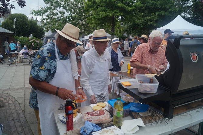 - Rotarians Geoff Hicks, Bill Parker and Struan Coupar serve up some sausages and burgers - Dartmouth Rotary Club 