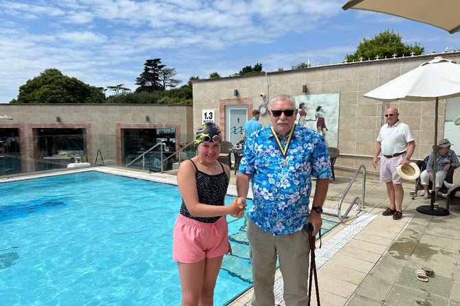 Swimmer Emily Worthington with Kingsbridge Rotary President Alan Thorpe