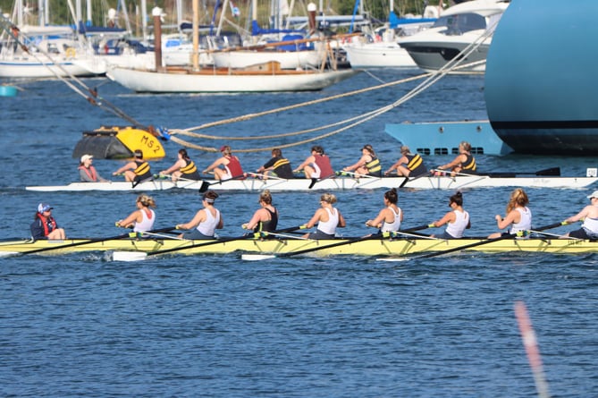 Rowers pass the superyacht Aviva