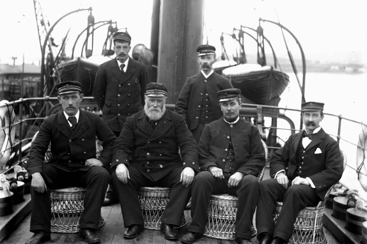 Captain and officers of a passenger steamer. All seated on deck.