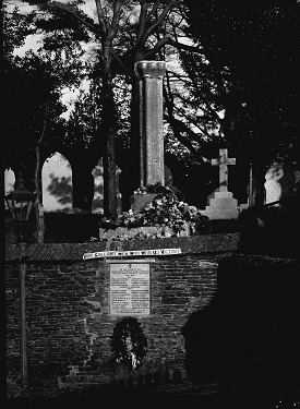 Dodbrooke war memorial, 1914-18 war. Shows pillar, caption on wall, flowers - possibly decorated for special occasion.